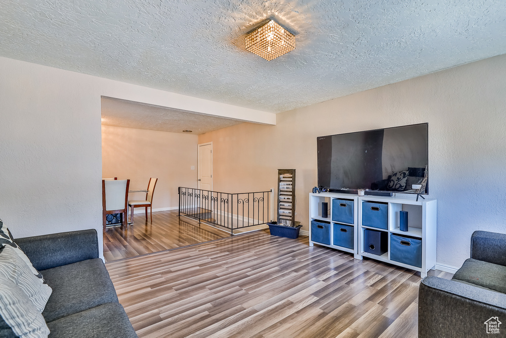 Living room featuring a textured ceiling and hardwood / wood-style floors