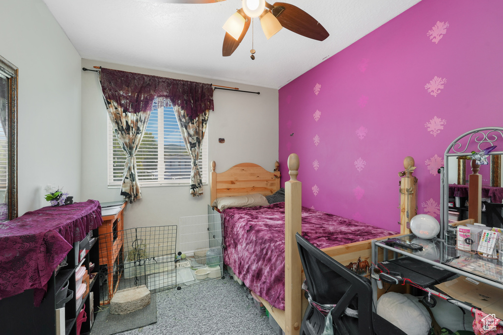 Carpeted bedroom featuring ceiling fan