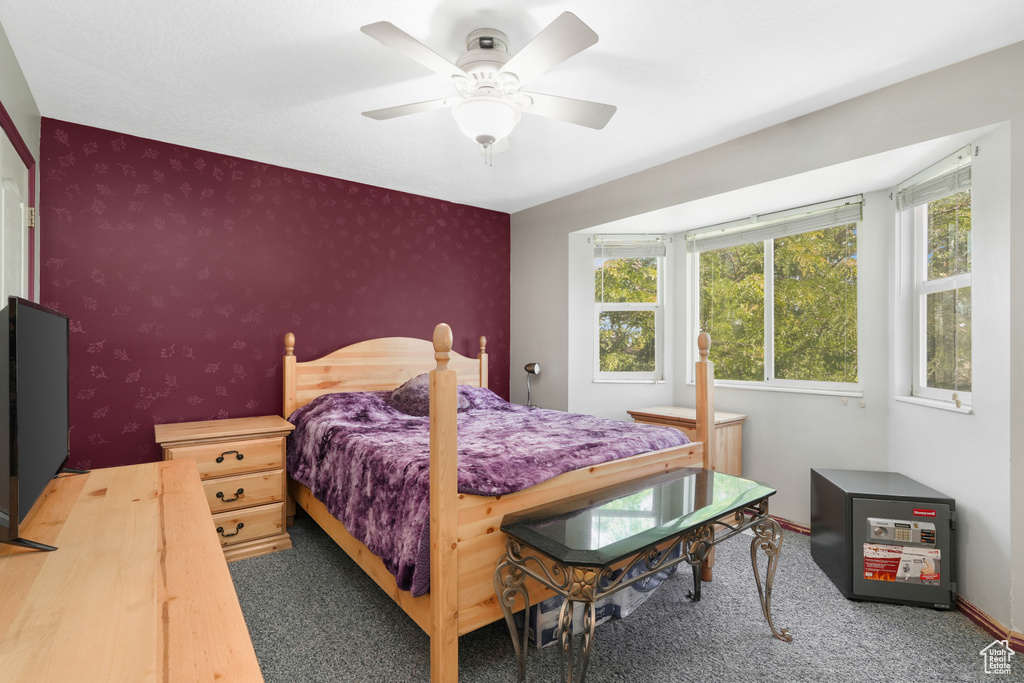 Bedroom with multiple windows, carpet, and ceiling fan