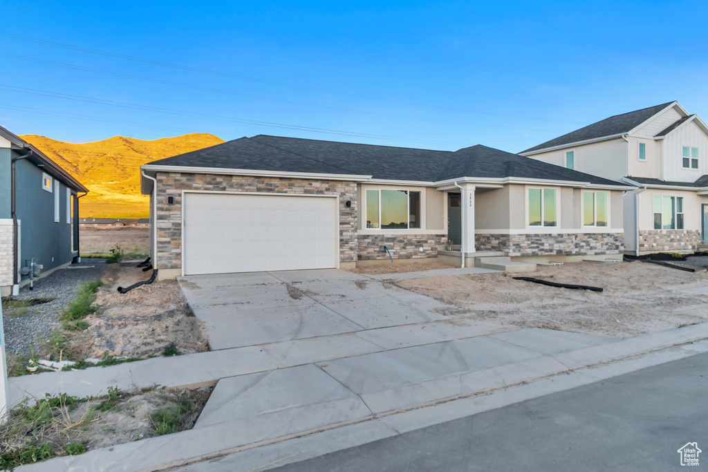 View of front facade featuring a garage and a mountain view