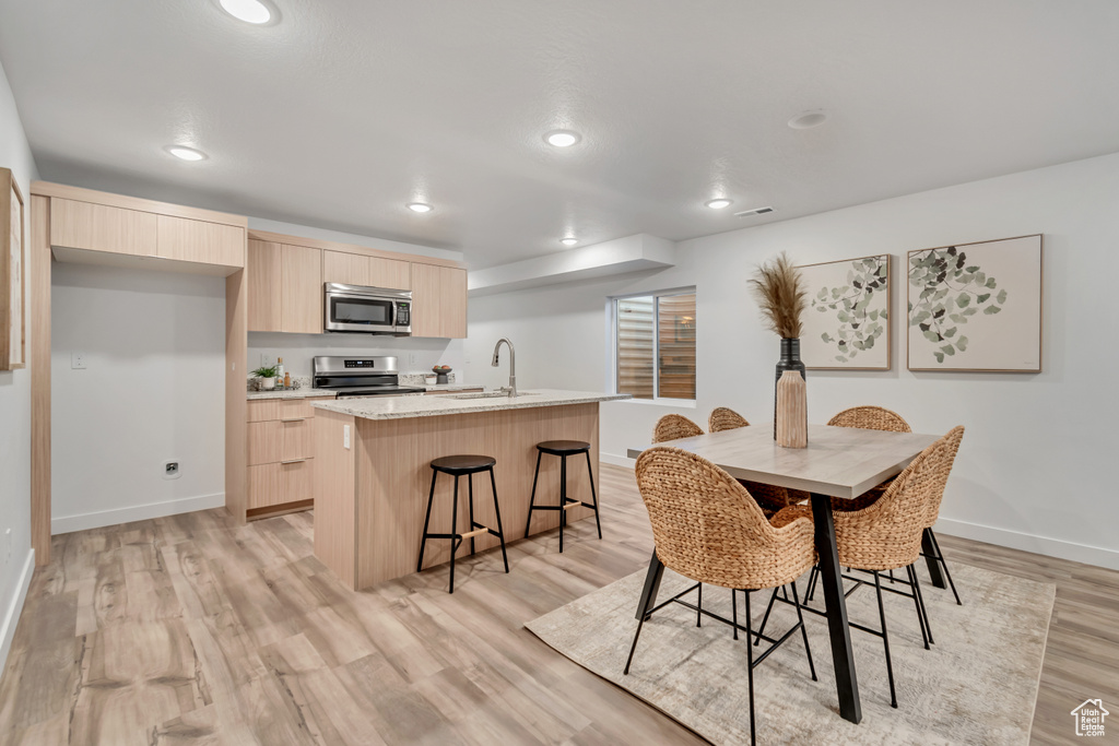 Dining room featuring light hardwood / wood-style floors and sink