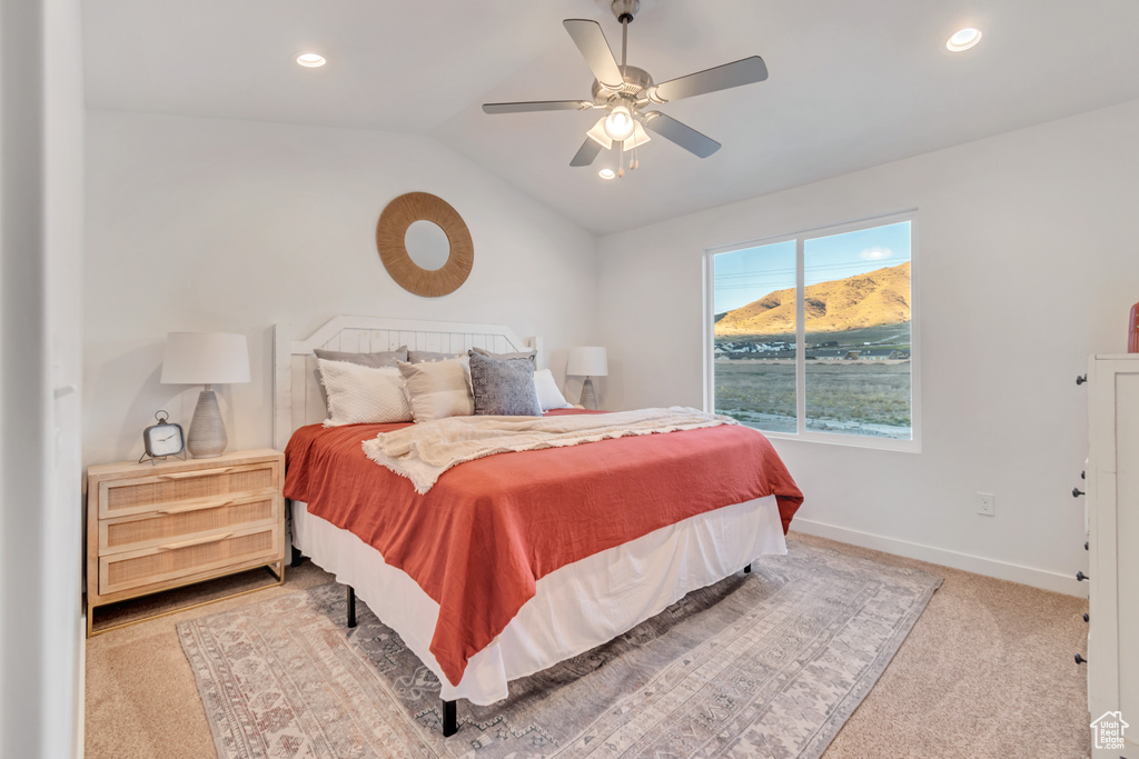 Bedroom featuring carpet floors, ceiling fan, and vaulted ceiling