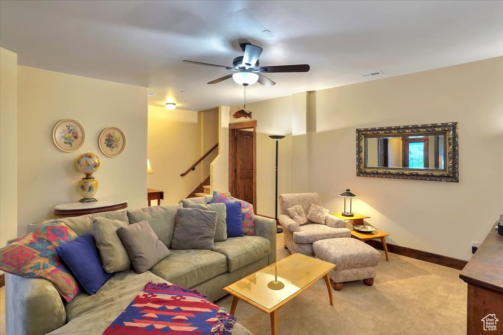 Living room featuring carpet floors and ceiling fan