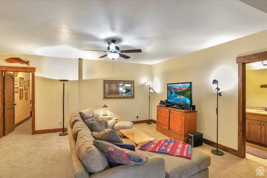 Carpeted living room with ceiling fan