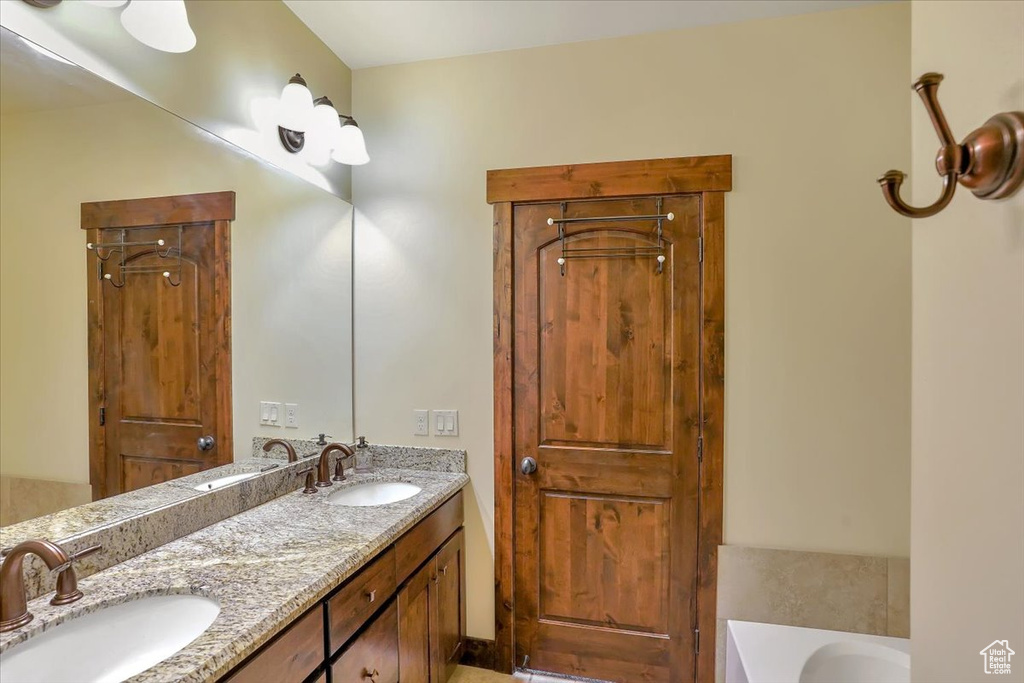 Bathroom with dual vanity and a bath
