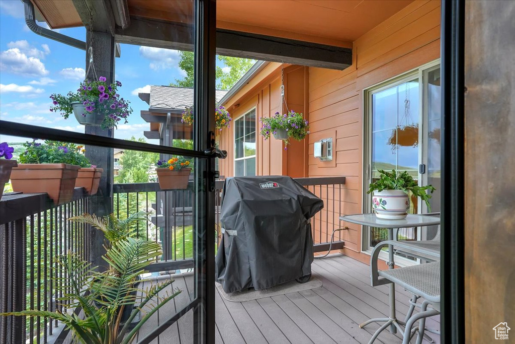 Wooden balcony with area for grilling and a wooden deck