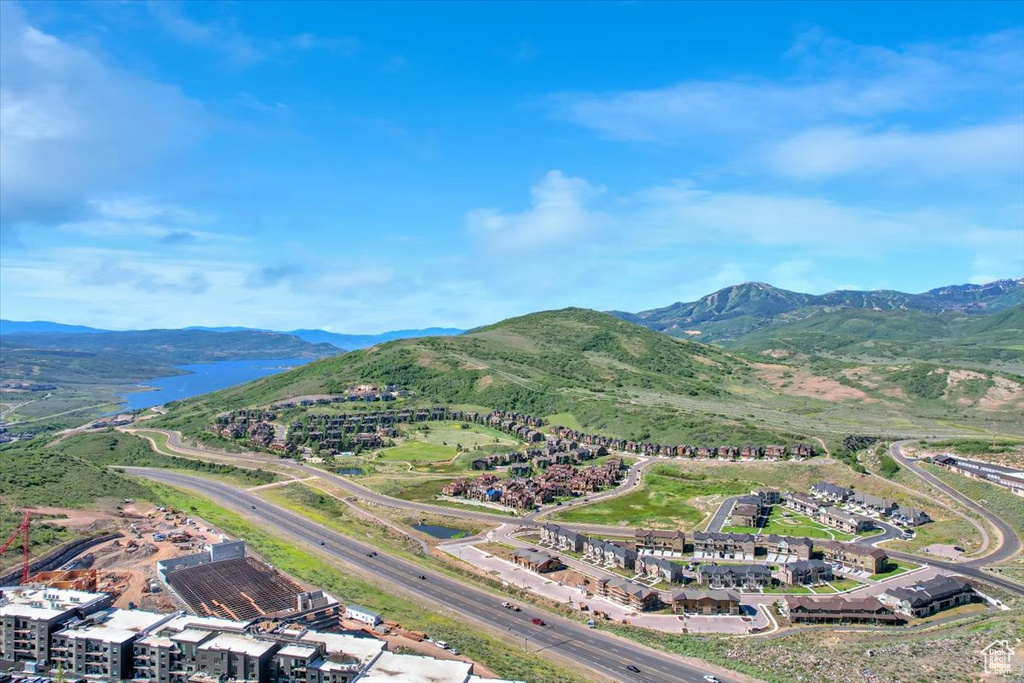 Birds eye view of property featuring a water and mountain view