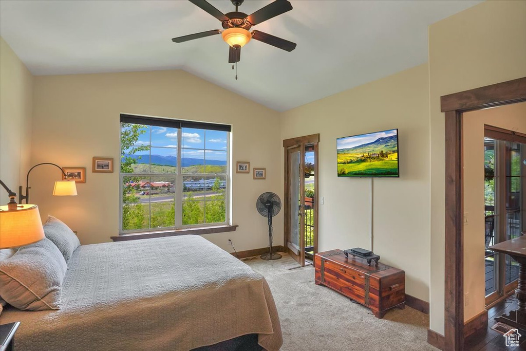 Bedroom featuring vaulted ceiling, carpet, ceiling fan, and access to outside