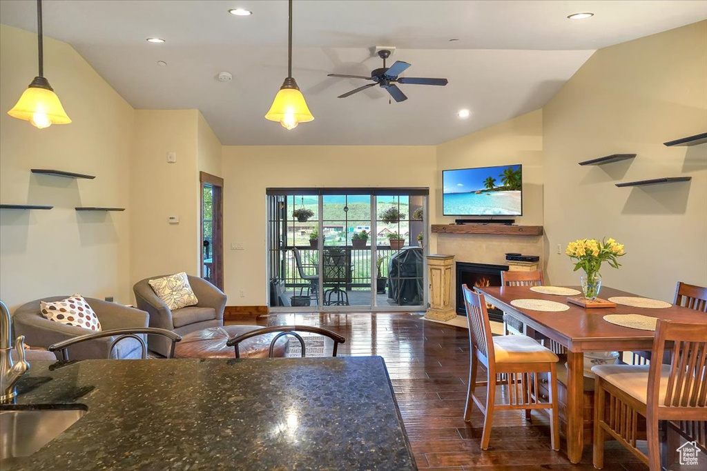 Dining area featuring vaulted ceiling, dark hardwood / wood-style flooring, and ceiling fan