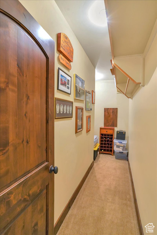 Corridor featuring light carpet