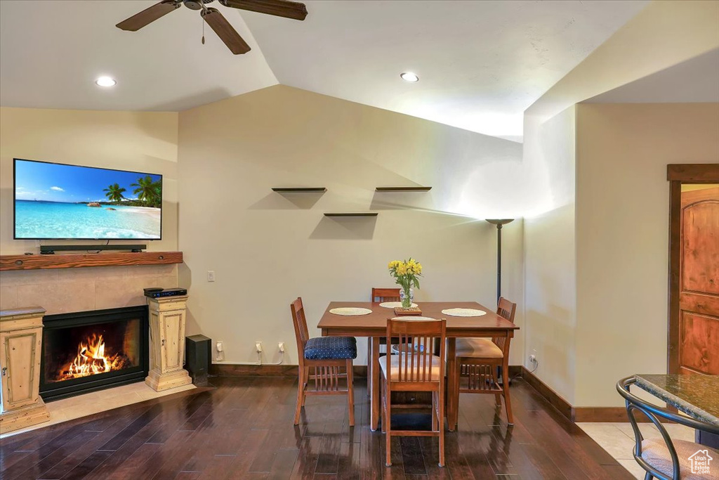 Dining area with ceiling fan, vaulted ceiling, and hardwood / wood-style floors