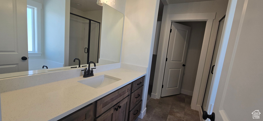 Bathroom featuring vanity and shower with separate bathtub