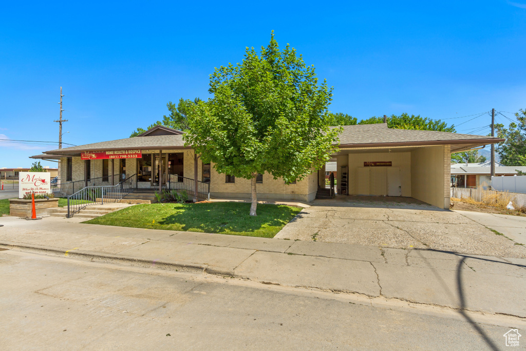 View of front of home featuring a carport and a porch