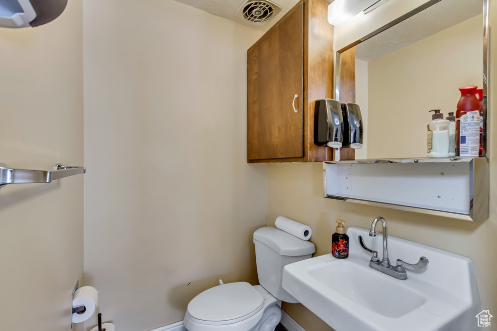 Bathroom featuring sink and toilet