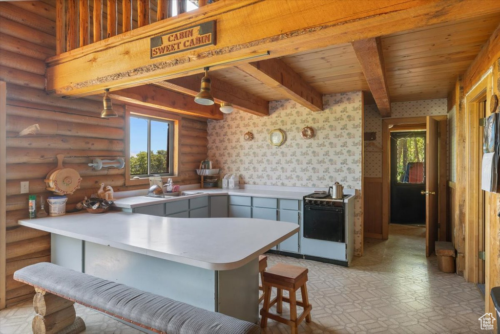 Kitchen with beam ceiling, rustic walls, light tile floors, sink, and wooden ceiling