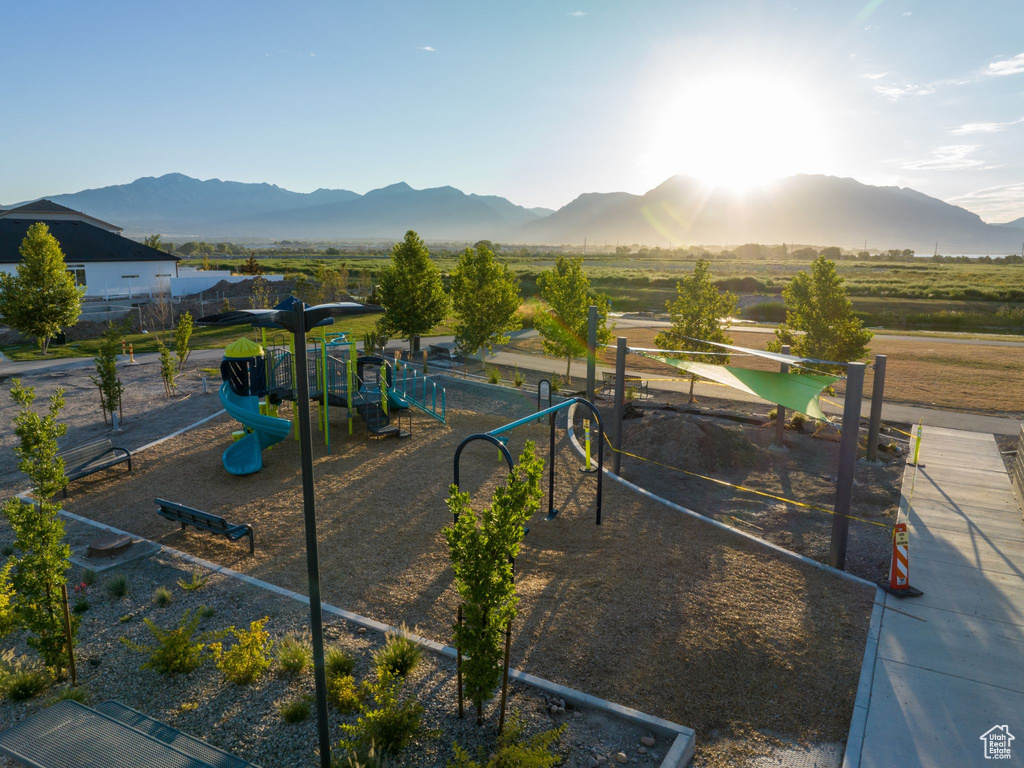 Surrounding community featuring a mountain view and a playground