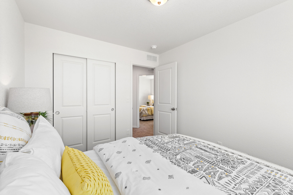 Bedroom featuring a closet and carpet flooring