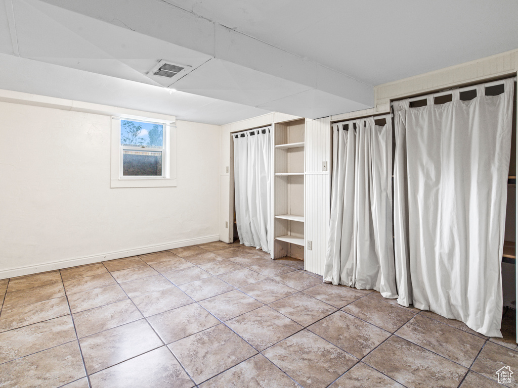 Unfurnished bedroom featuring tile flooring