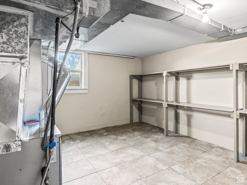 Basement with light tile floors