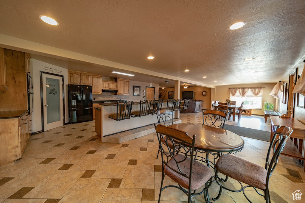 Dining space with a textured ceiling and light tile floors