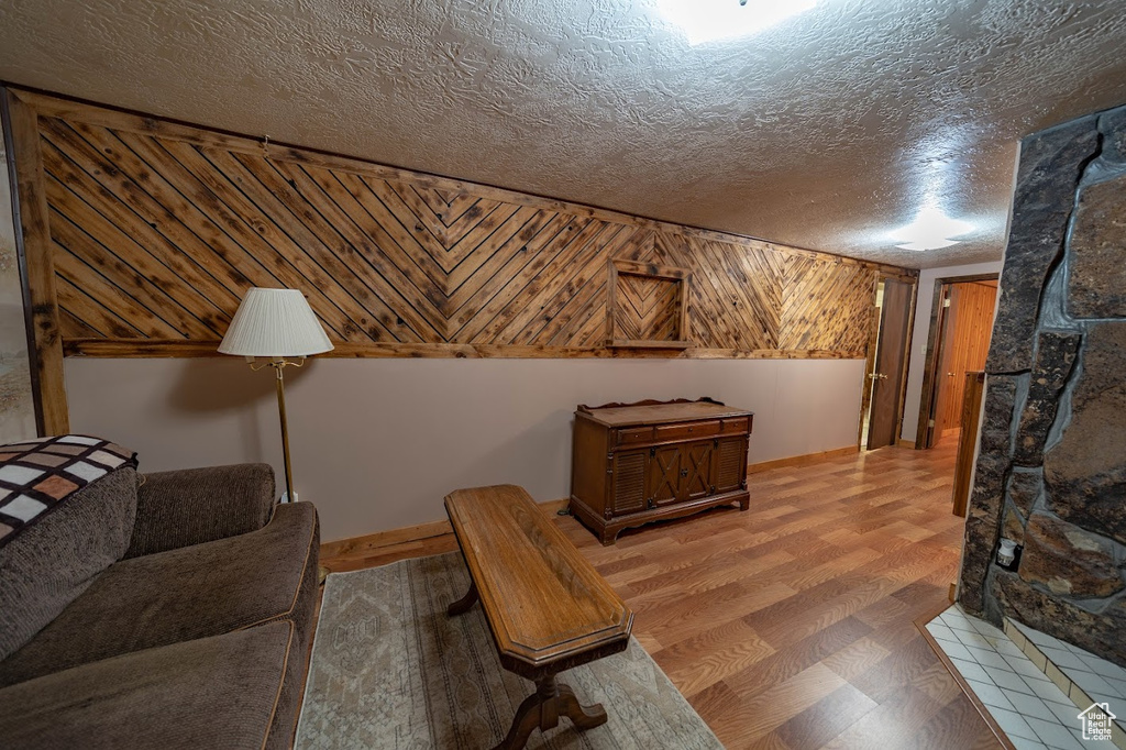 Living room featuring a textured ceiling and wood-type flooring