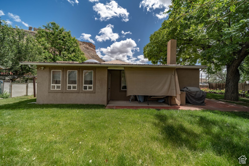 Rear view of house with a lawn