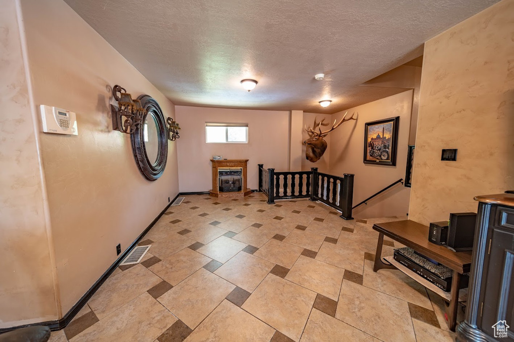 Entryway with a textured ceiling and light tile floors