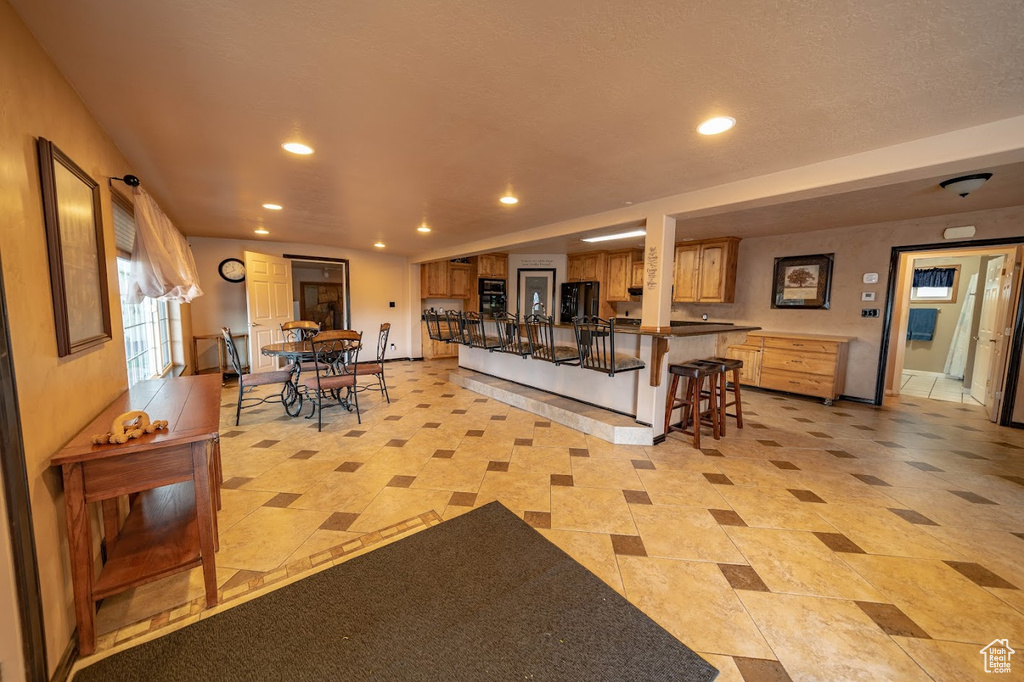 Tiled living room with a textured ceiling