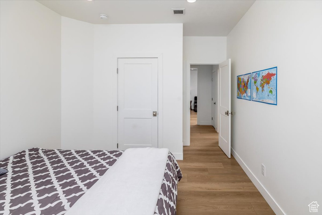 Bedroom with light hardwood / wood-style flooring