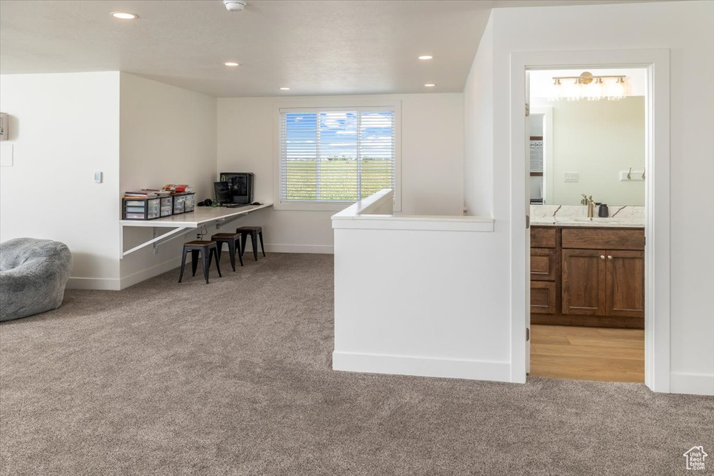 Carpeted office featuring sink