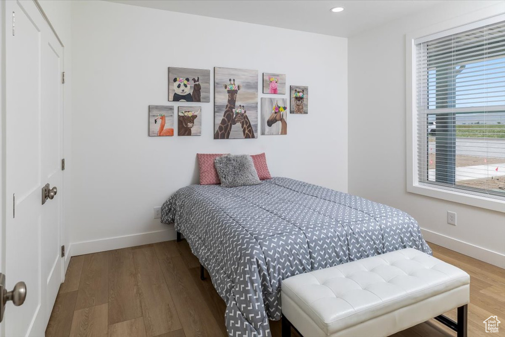 Bedroom with hardwood / wood-style flooring