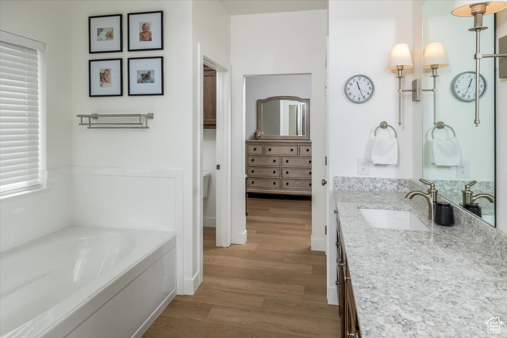 Bathroom featuring a bathtub, hardwood / wood-style flooring, and vanity