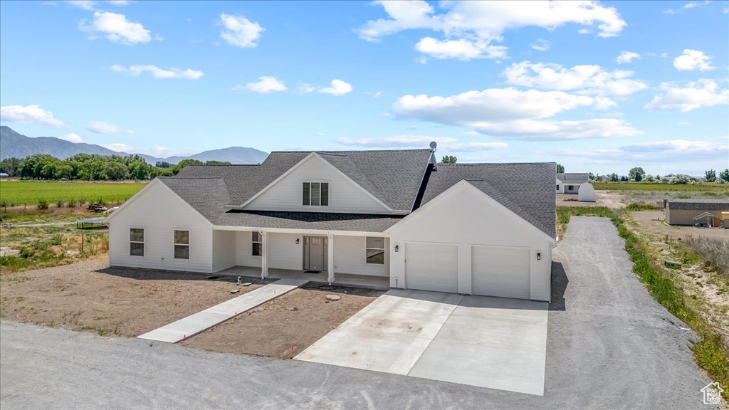 View of front of house featuring a garage and a mountain view