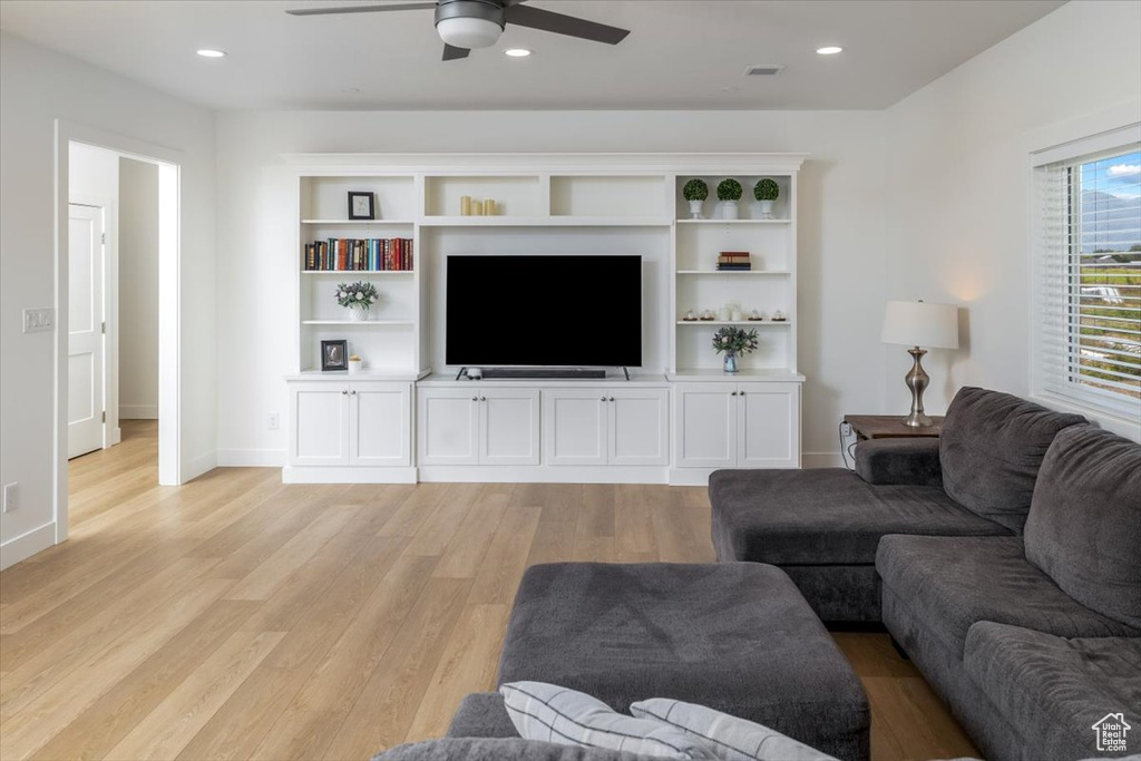 Living room featuring ceiling fan and light wood-type flooring