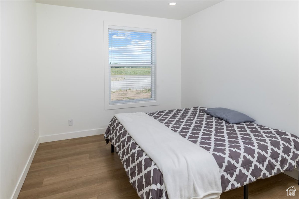 Bedroom with hardwood / wood-style flooring