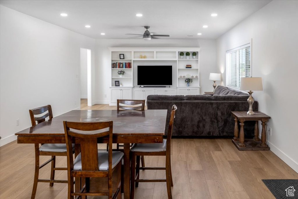 Dining area with light hardwood / wood-style floors and ceiling fan