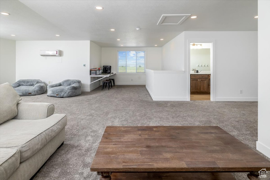 Carpeted living room with a wall mounted air conditioner