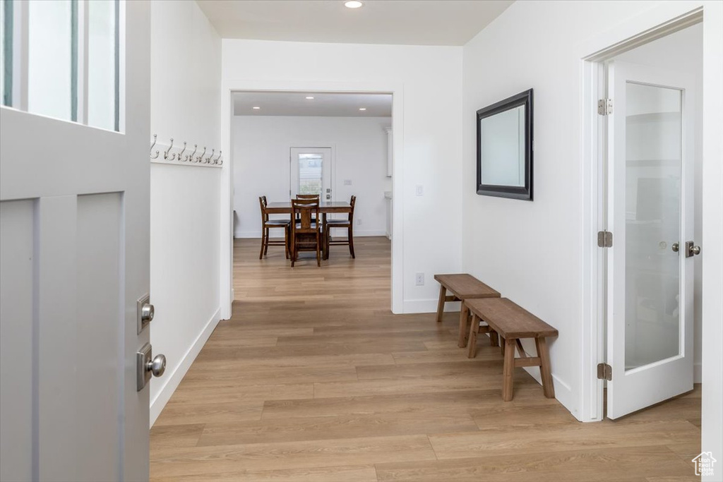 Hall with light hardwood / wood-style flooring