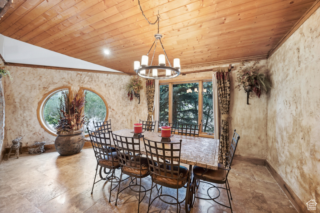 Tiled dining room featuring a notable chandelier, vaulted ceiling, and wooden ceiling