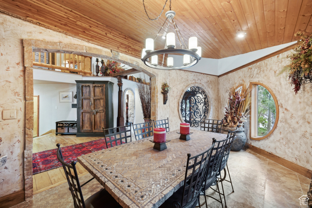 Dining area featuring a notable chandelier, lofted ceiling, and wood ceiling