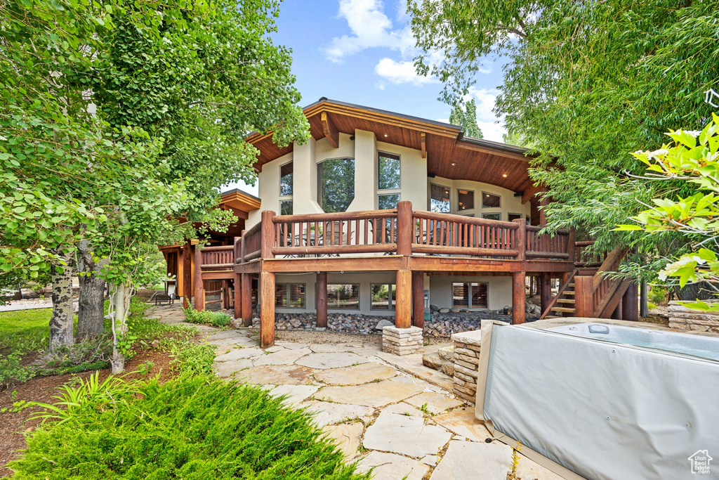 Back of property featuring a wooden deck