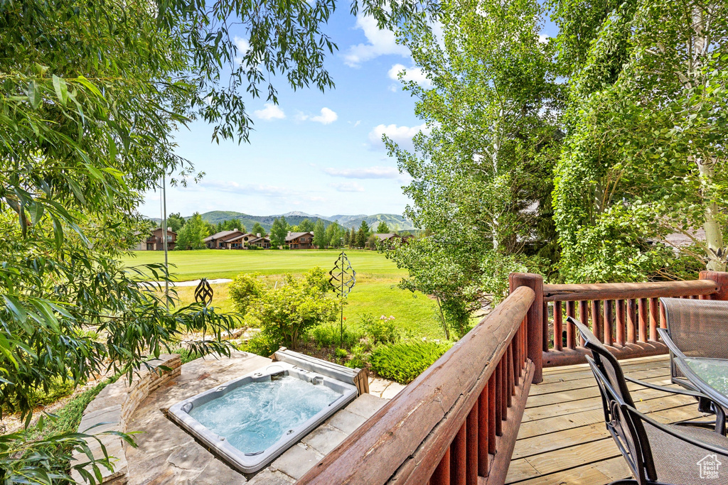 Wooden terrace with a yard and a mountain view