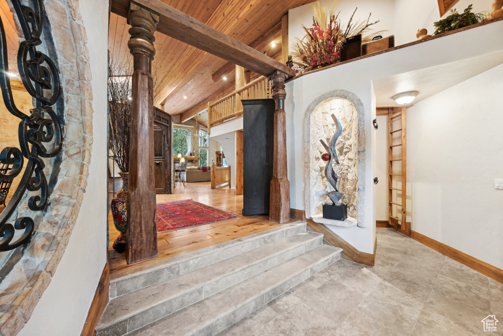 Foyer featuring wooden ceiling, lofted ceiling with beams, and hardwood / wood-style flooring