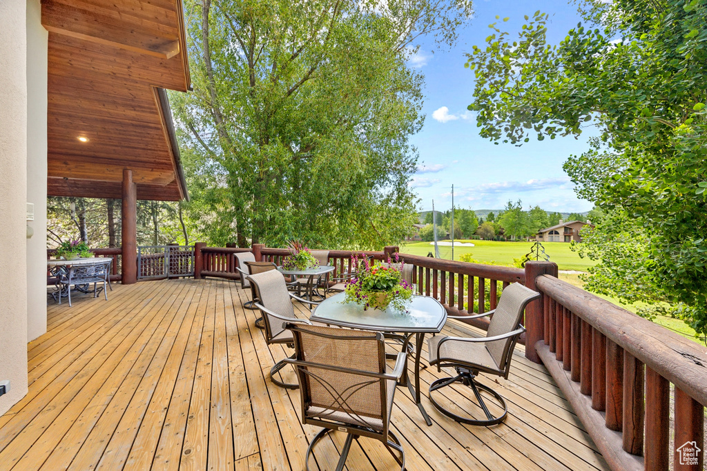 Wooden deck featuring a lawn