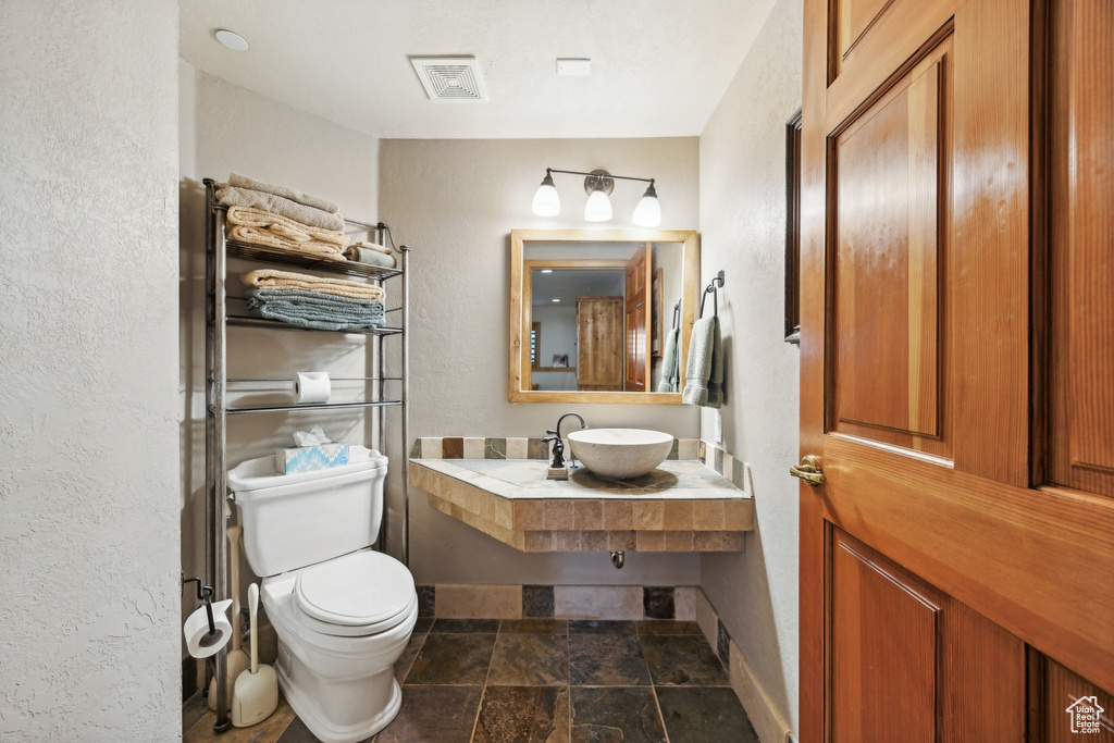 Bathroom with tile flooring, sink, and toilet