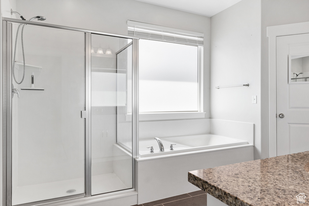 Bathroom featuring separate shower and tub and tile patterned floors