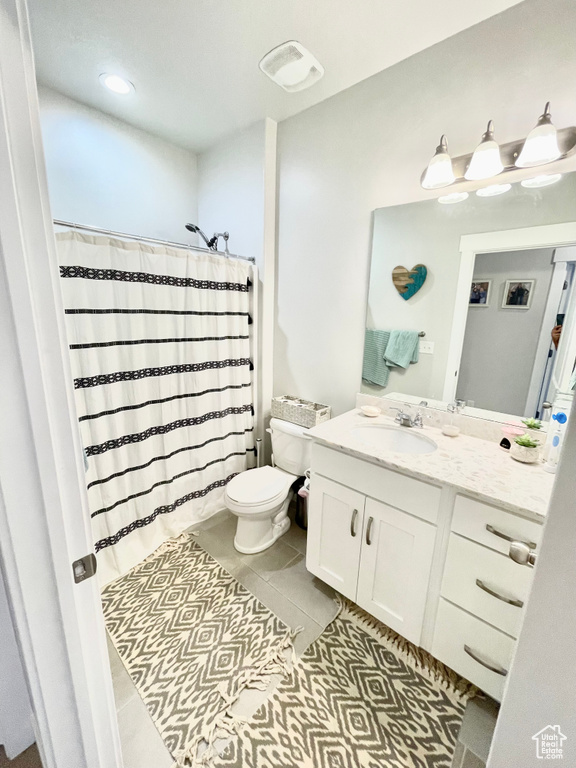 Bathroom featuring tile flooring, toilet, and vanity