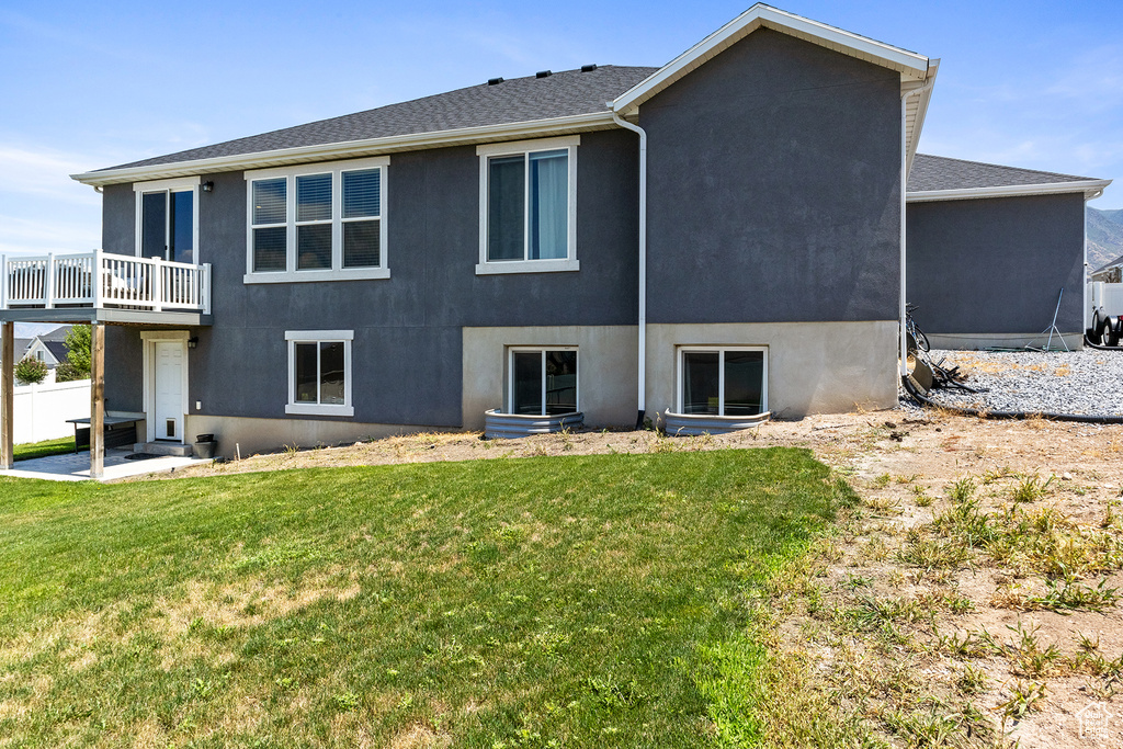 Rear view of property featuring a lawn