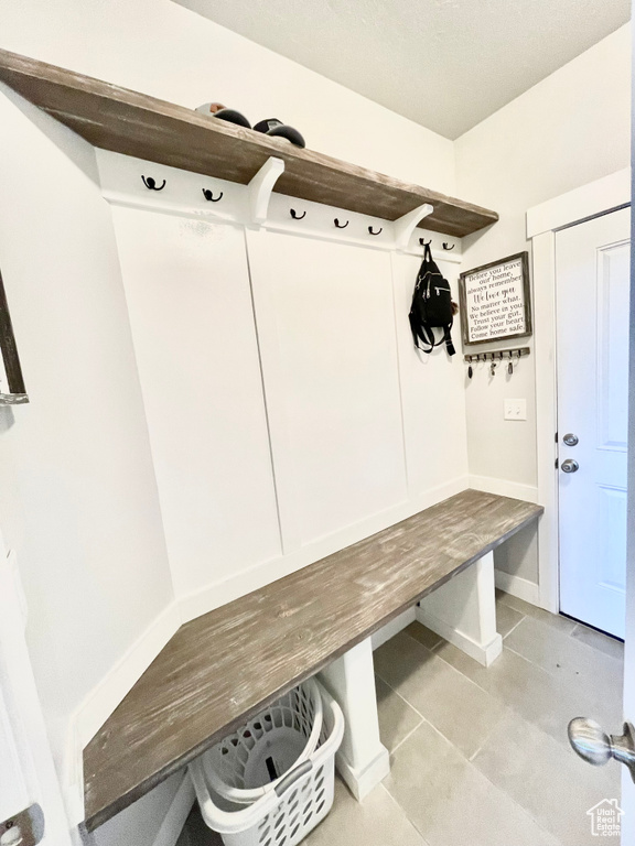 Mudroom with light tile flooring