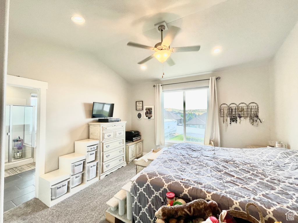 Bedroom featuring ceiling fan, vaulted ceiling, light colored carpet, access to outside, and connected bathroom